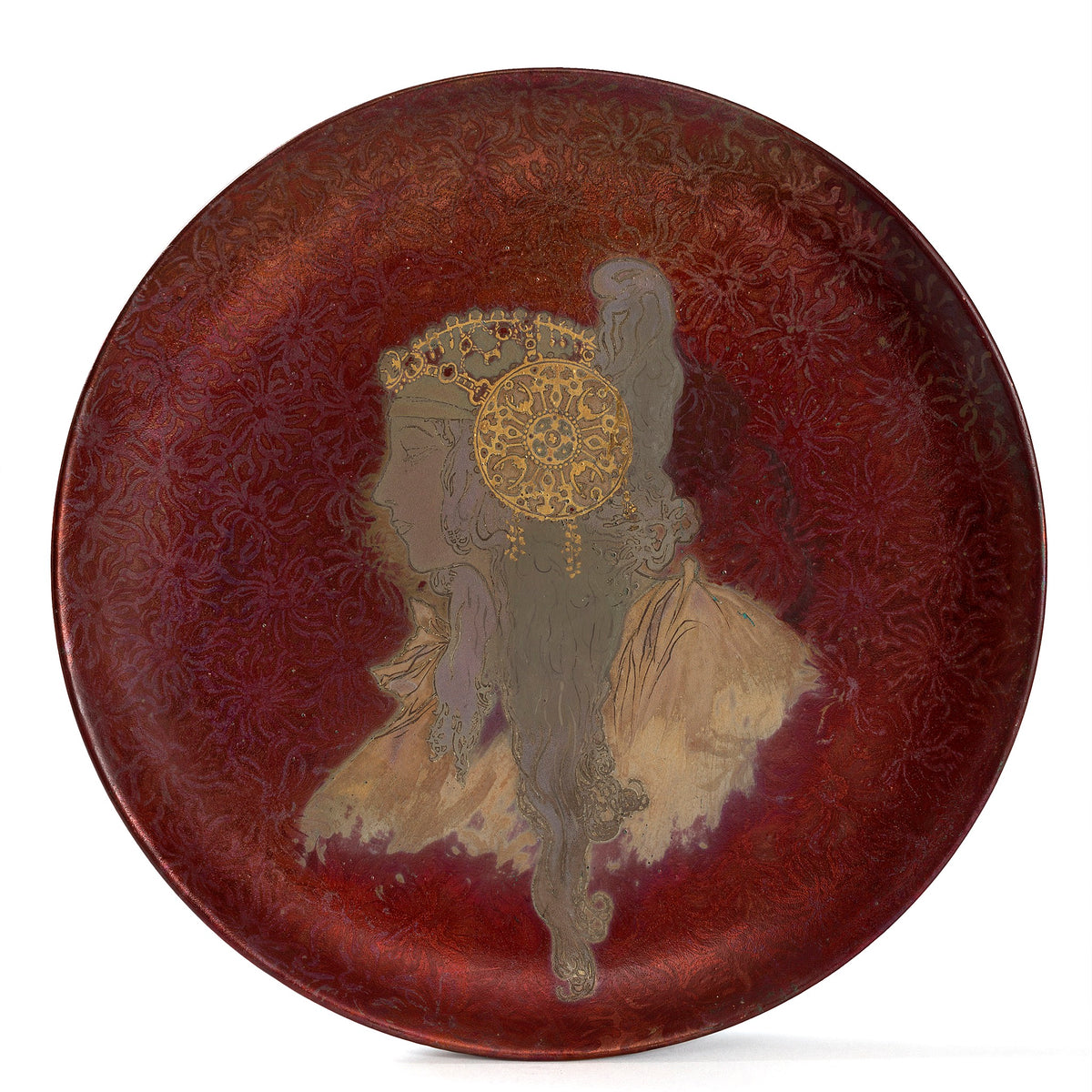 Macklowe Gallery A French Art Nouveau iridescent enamel-glazed ceramic charger by Clément Massier, after a design by Alphonse Mucha, depicting a woman's profile in Byzantine dress and jewels.  